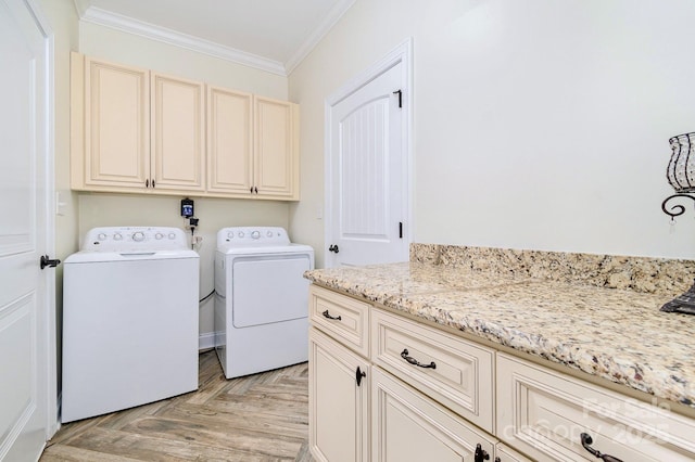 washroom featuring cabinet space, independent washer and dryer, and ornamental molding