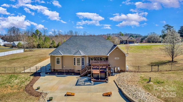 back of property with a deck, a patio, a yard, and a fenced backyard