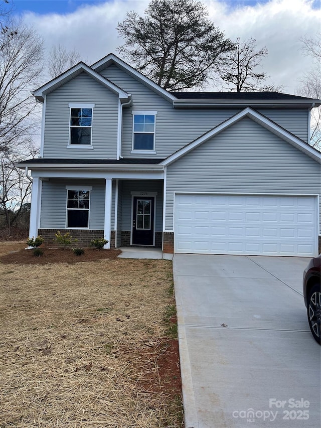 traditional-style home with an attached garage, covered porch, brick siding, and driveway