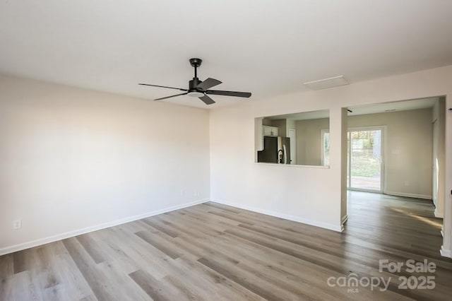 unfurnished room with ceiling fan, baseboards, and wood finished floors