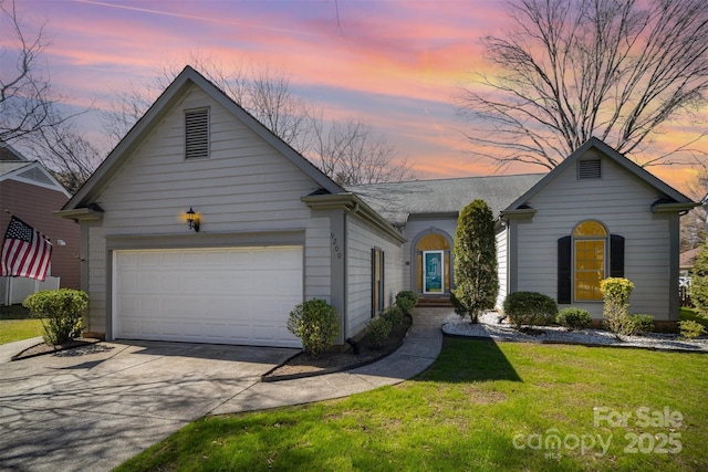 view of front facade featuring driveway, a garage, and a front lawn