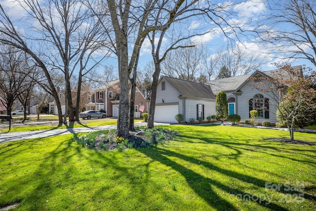 view of front of property with a garage and a front lawn