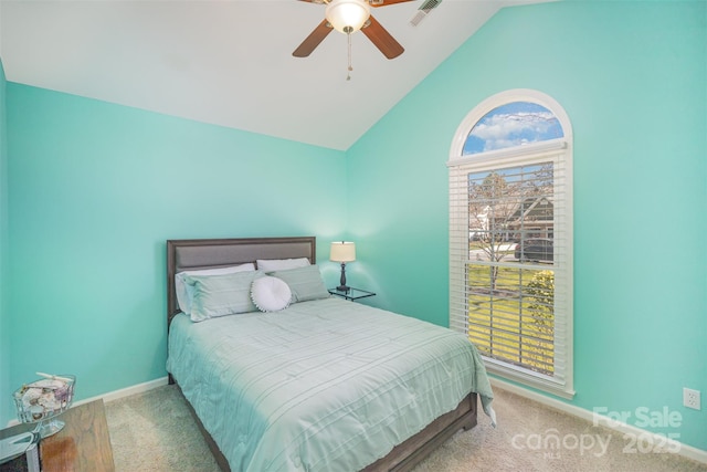 carpeted bedroom featuring lofted ceiling, multiple windows, visible vents, and baseboards