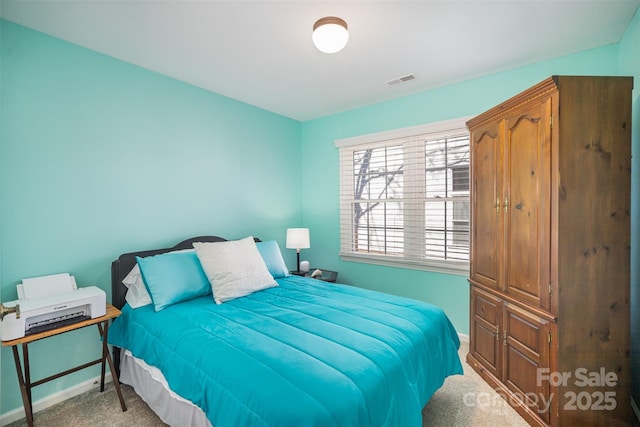 bedroom with carpet flooring, visible vents, and baseboards