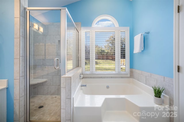 full bathroom with a garden tub and a shower stall