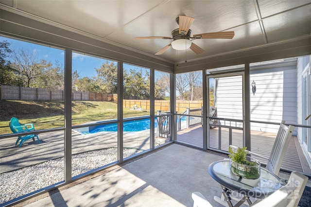 unfurnished sunroom with ceiling fan and plenty of natural light