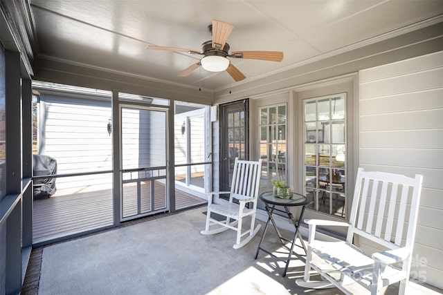 sunroom / solarium featuring ceiling fan