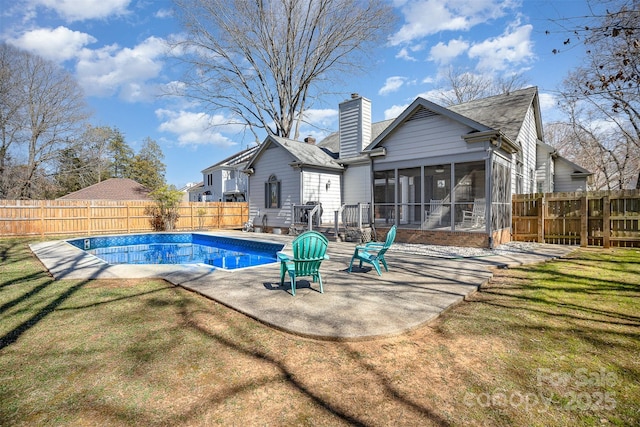 view of pool featuring a sunroom, a fenced backyard, a fenced in pool, and a yard