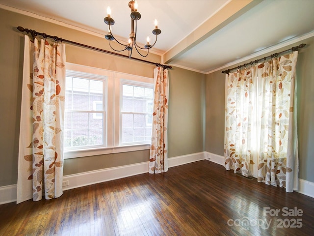 empty room with a notable chandelier, hardwood / wood-style floors, ornamental molding, beamed ceiling, and baseboards