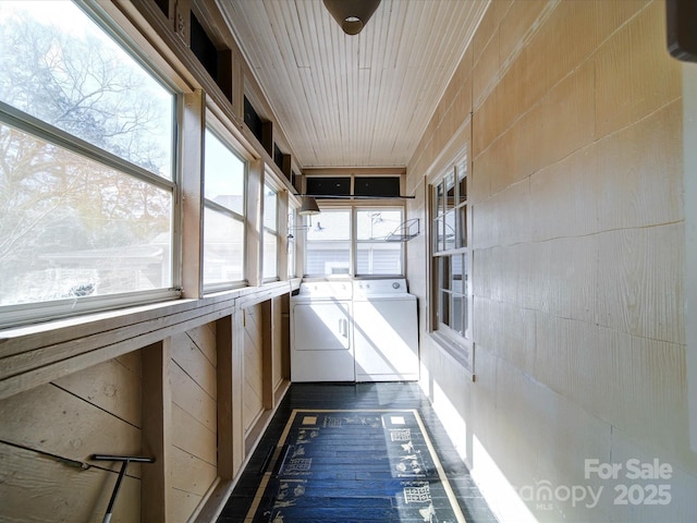 unfurnished sunroom with washing machine and clothes dryer