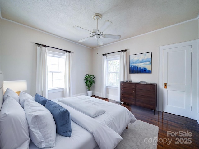 bedroom featuring a textured ceiling, wood finished floors, and crown molding