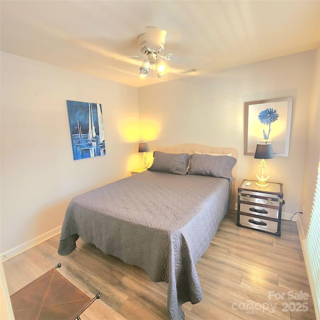 bedroom featuring visible vents, wood finished floors, baseboards, and ceiling fan