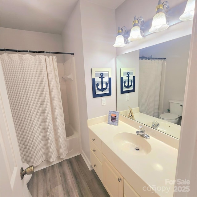 bathroom featuring vanity, shower / bath combination with curtain, toilet, and wood finished floors