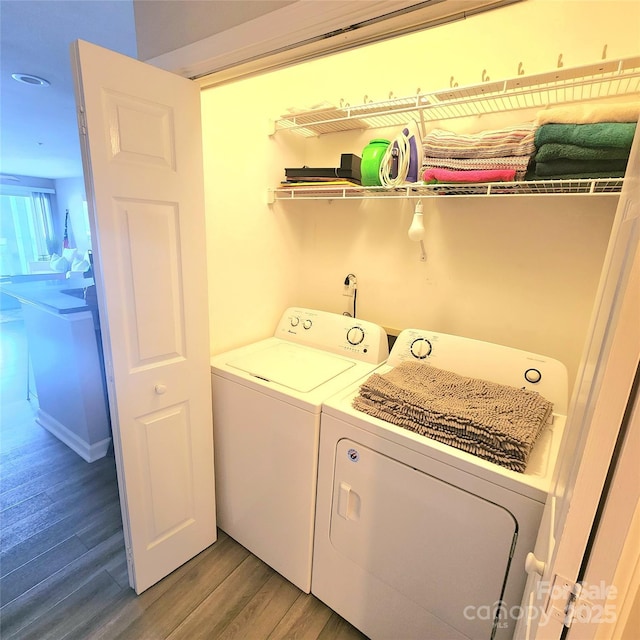 laundry room featuring washer and clothes dryer, laundry area, and light wood-type flooring