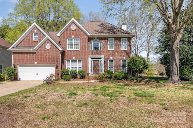 12723 Willingdon Rd, Huntersville, NC 28078 - colonial home with concrete driveway, a chimney, brick siding, a front lawn, and a garage