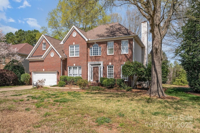 12723 Willingdon Rd, Huntersville, NC 28078 - colonial house with brick siding, driveway, a garage, and a chimney