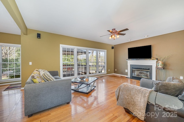 12723 Willingdon Rd, Huntersville, NC 28078 - living area with plenty of natural light, light wood-type flooring, a fireplace with flush hearth, and a ceiling fan