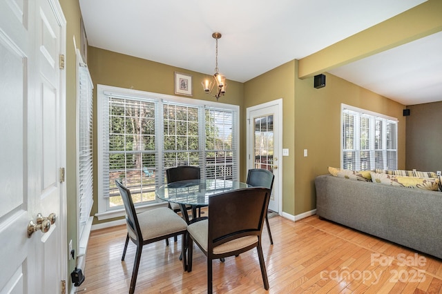 12723 Willingdon Rd, Huntersville, NC 28078 - dining space featuring baseboards, light wood-style flooring, beam ceiling, and a chandelier