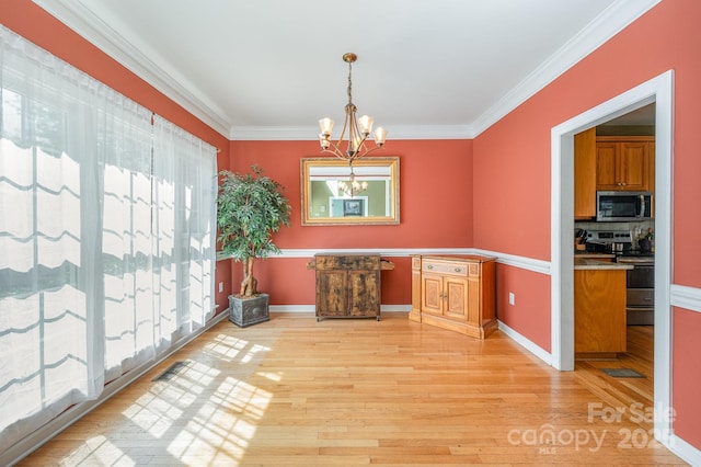 12723 Willingdon Rd, Huntersville, NC 28078 - unfurnished dining area featuring light wood finished floors, ornamental molding, a chandelier, and visible vents