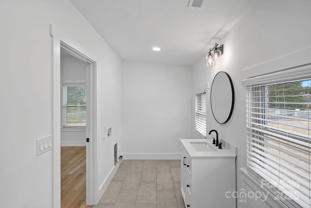 bathroom featuring vanity, visible vents, baseboards, recessed lighting, and tile patterned floors