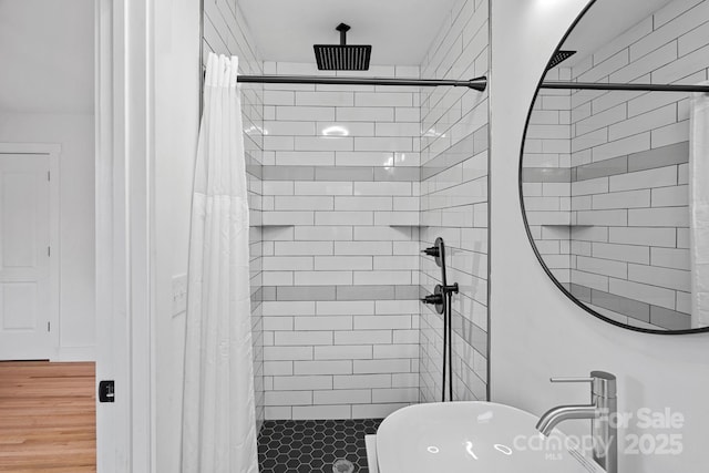 full bathroom featuring a shower stall and a sink