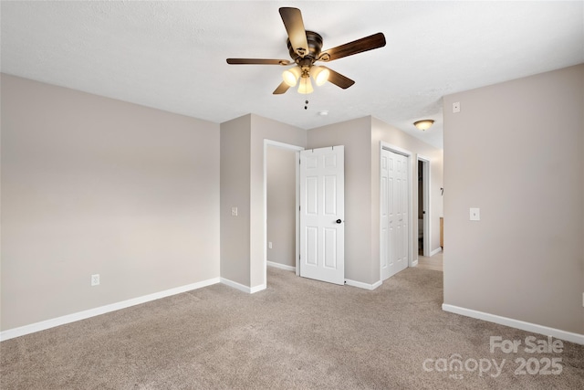 unfurnished bedroom featuring carpet flooring, a ceiling fan, baseboards, and a closet