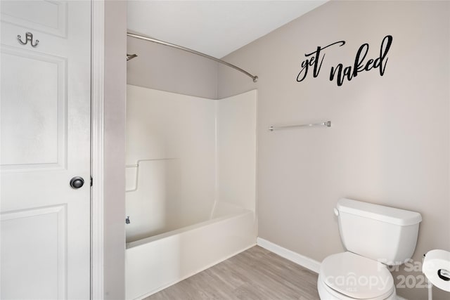 full bath featuring baseboards, toilet, bathtub / shower combination, and wood finished floors