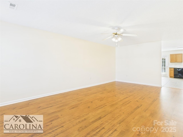 unfurnished living room featuring light wood-type flooring, baseboards, visible vents, and a ceiling fan