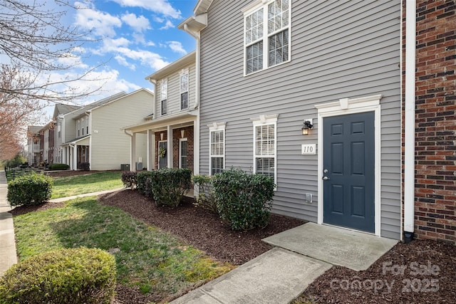 entrance to property with a lawn