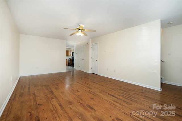 unfurnished living room with baseboards, a ceiling fan, and wood finished floors