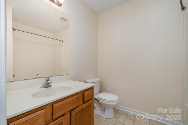 bathroom with visible vents, toilet, vanity, and walk in shower