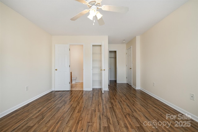 unfurnished bedroom featuring dark wood-style floors, a ceiling fan, and baseboards