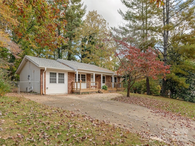 single story home featuring a porch and brick siding