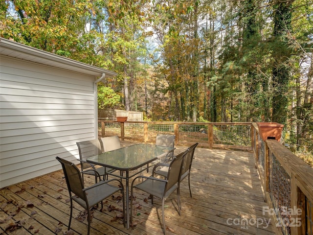 wooden deck featuring outdoor dining space