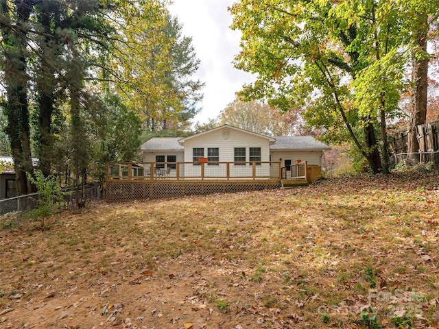 back of house featuring a fenced backyard and a deck