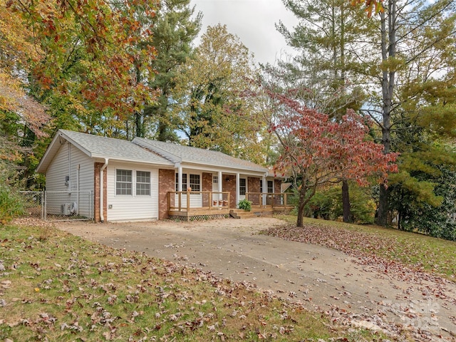 ranch-style home featuring brick siding and covered porch