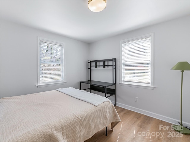 bedroom with baseboards and light wood-style flooring