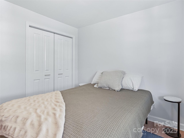 bedroom with a closet and baseboards