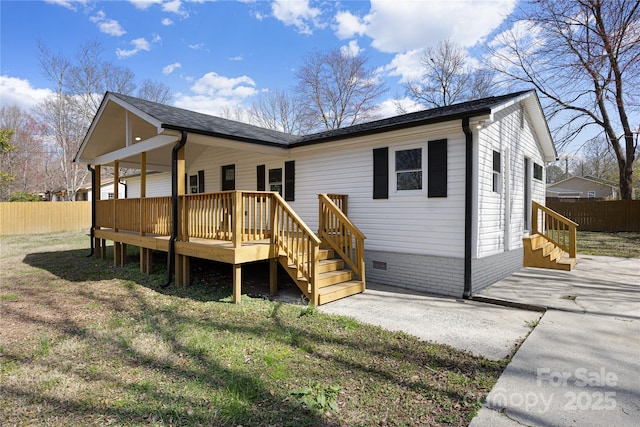 back of property featuring crawl space, a patio, a wooden deck, and fence