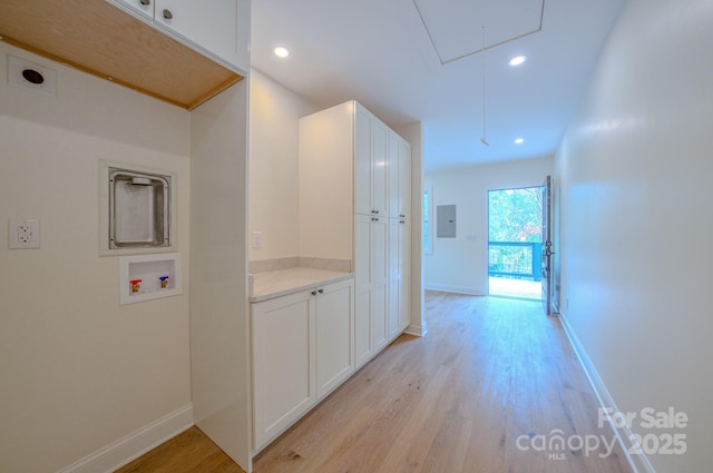 hallway featuring recessed lighting, light wood-style flooring, attic access, electric panel, and baseboards