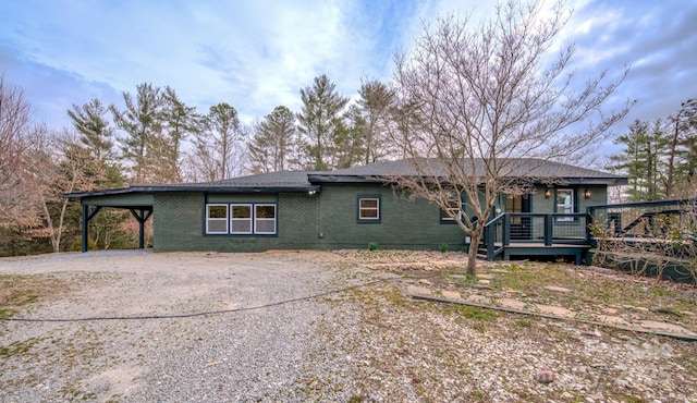 exterior space with driveway and brick siding