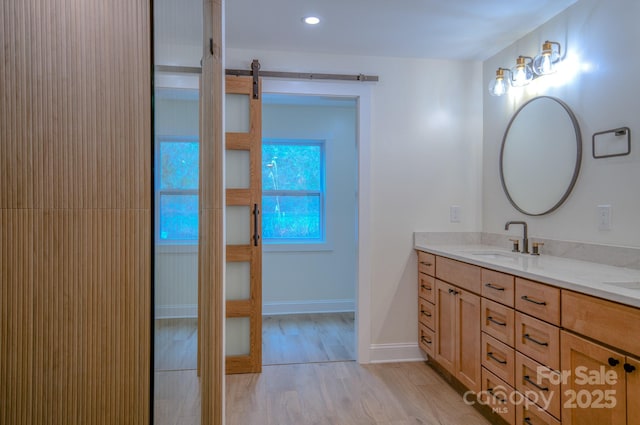 full bath with baseboards and vanity