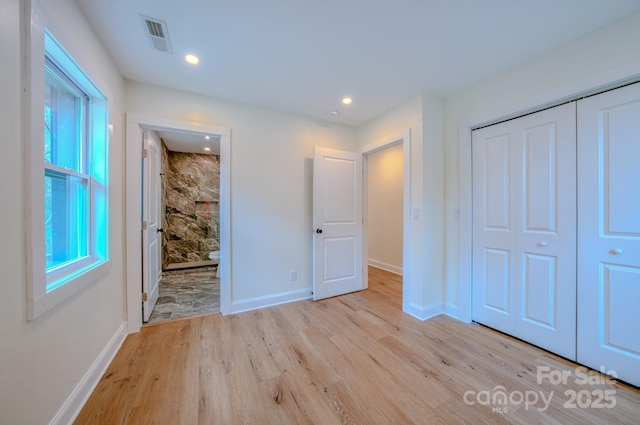 unfurnished bedroom featuring recessed lighting, a closet, visible vents, light wood-style flooring, and baseboards