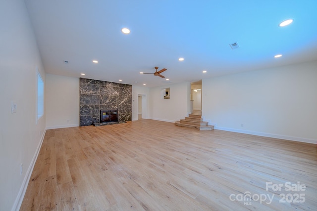 unfurnished living room featuring a fireplace, recessed lighting, visible vents, light wood-style flooring, and baseboards