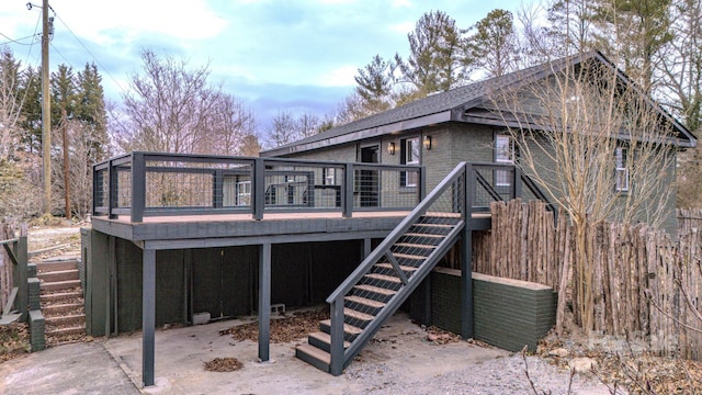 rear view of house with stairs and a deck