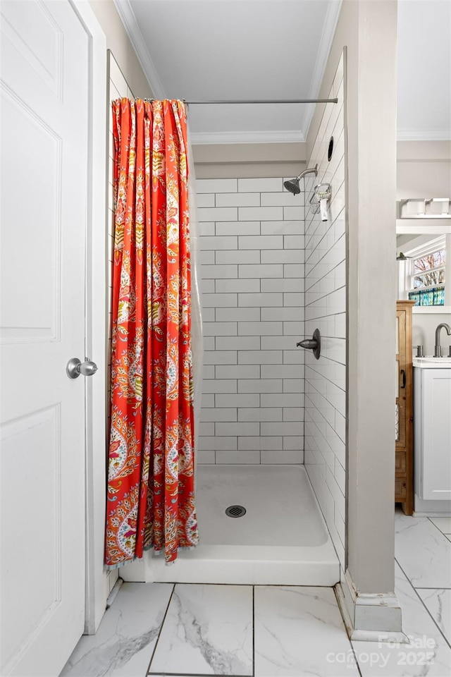 bathroom with marble finish floor, ornamental molding, and a shower stall