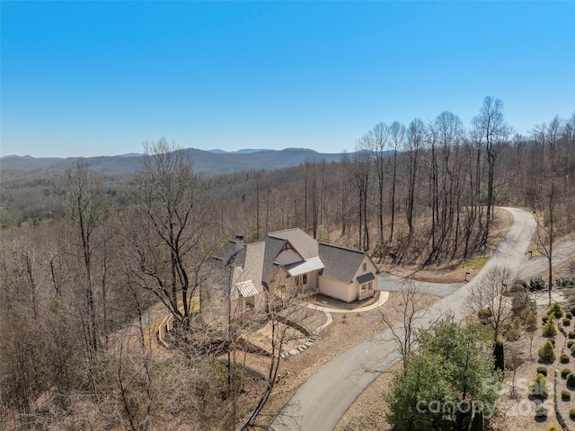 bird's eye view featuring a mountain view and a view of trees