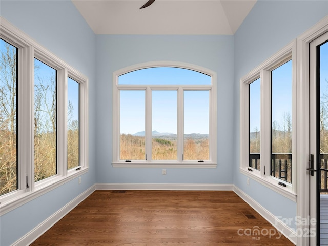 unfurnished sunroom featuring ceiling fan