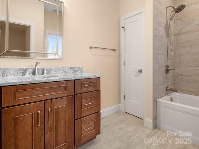 full bath featuring visible vents, baseboards, washtub / shower combination, wood finished floors, and vanity