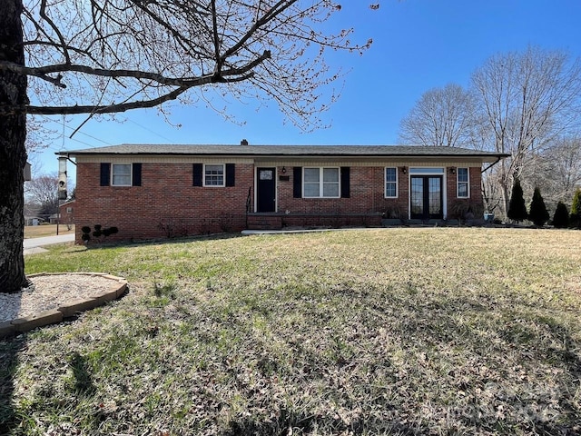 ranch-style home with brick siding and a front yard